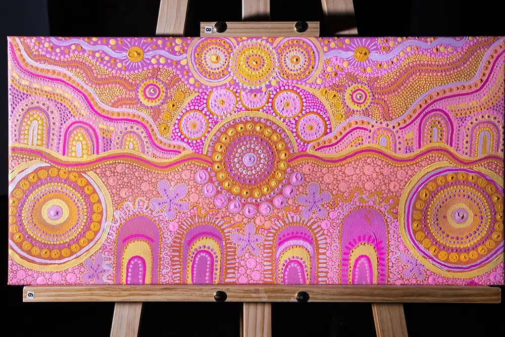 Coming together artwork displayed on an easel.